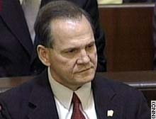 Moore listens as the ruling removing him from office is read Thursday.